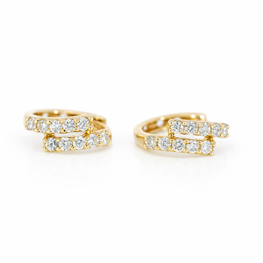 Gold hoop earrings with diamond accents on a white background