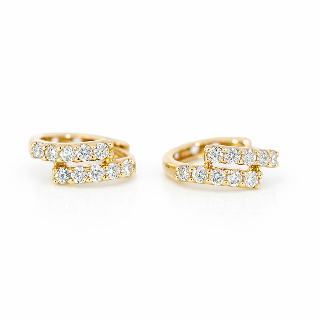 Gold hoop earrings with diamond accents on a white background