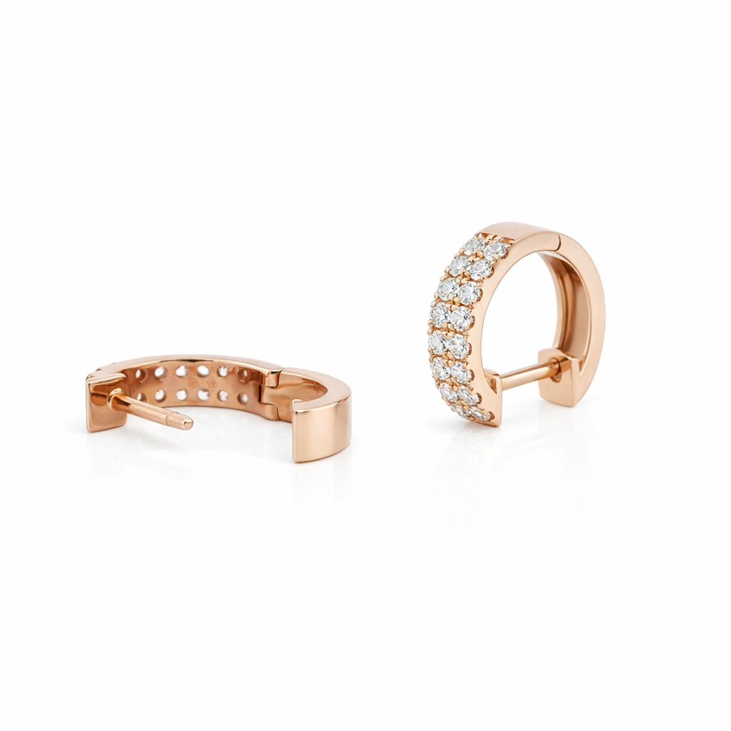 Rose gold hoop earrings with clear gemstones on a white background
